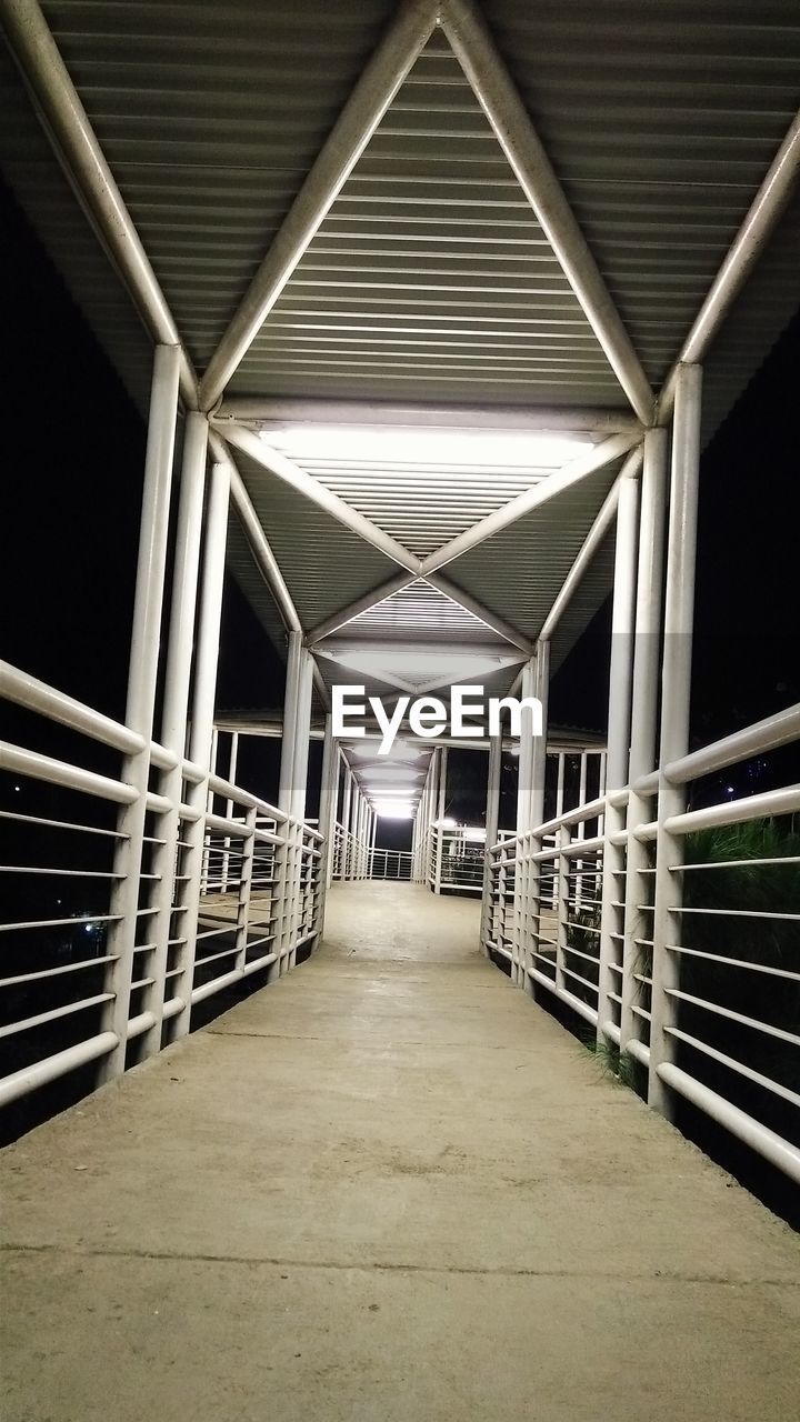 Illuminated footbridge at night