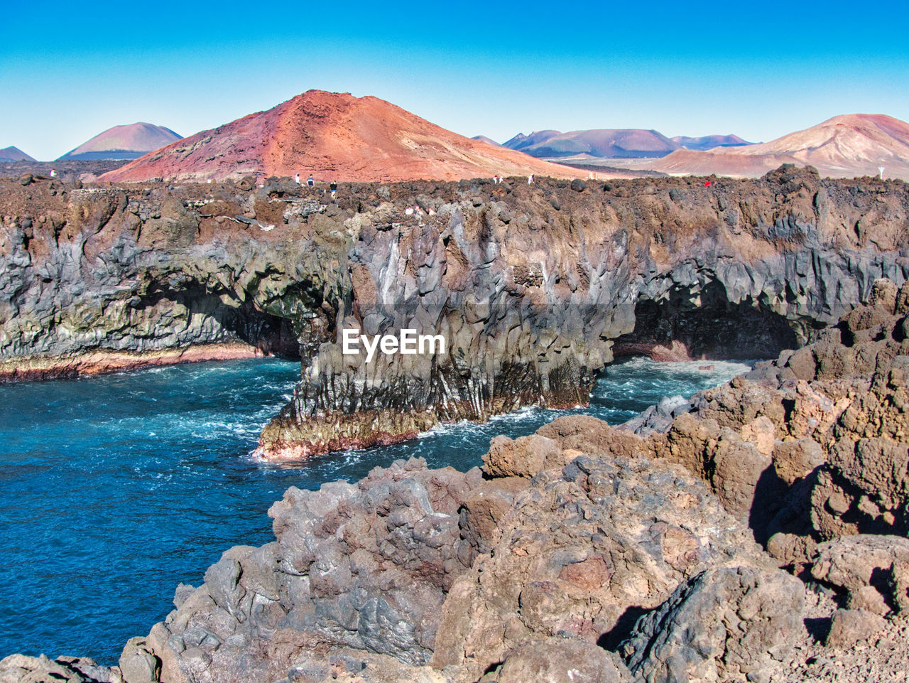 Scenic view of rocks in mountains against sky