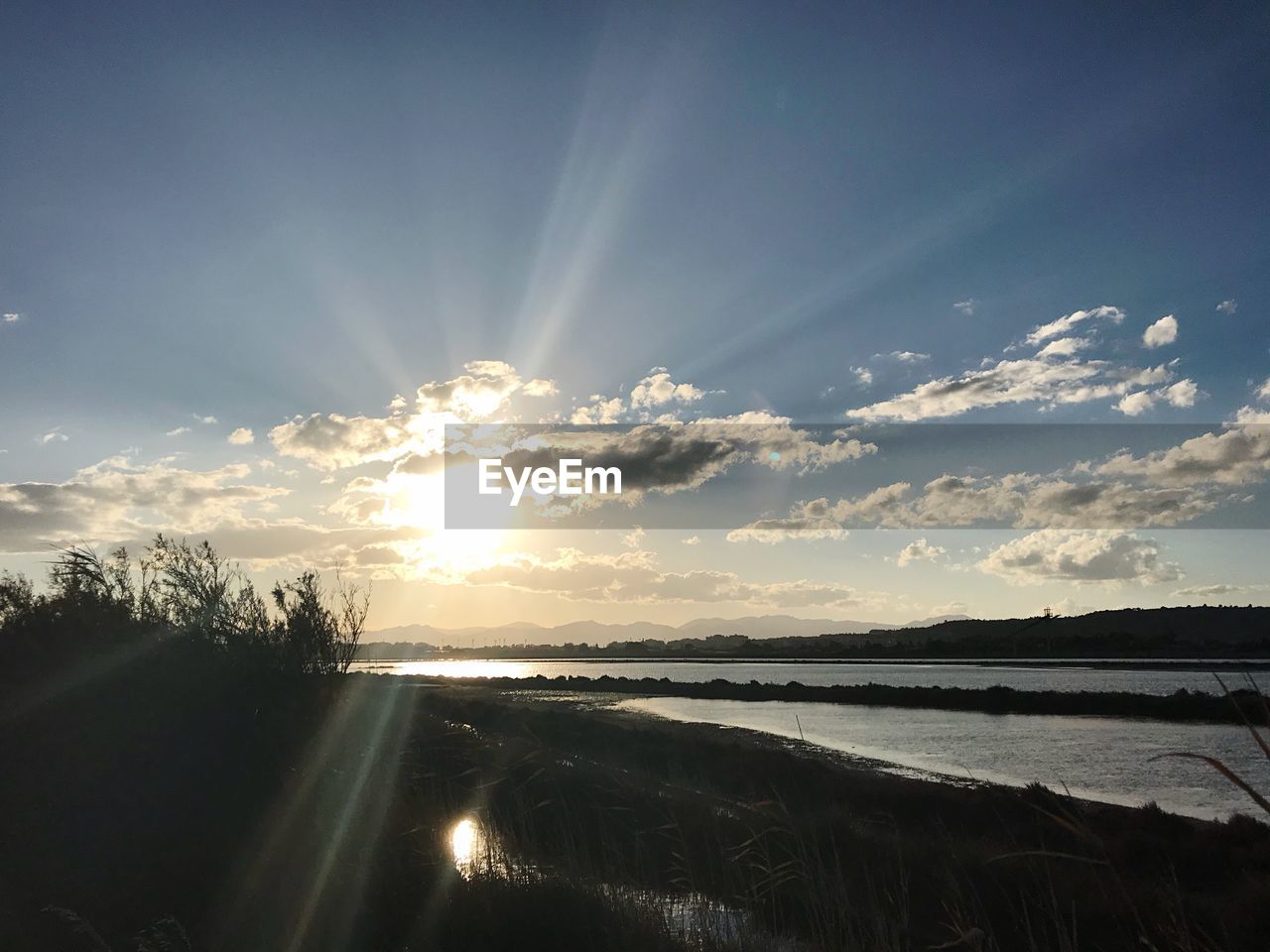 SCENIC VIEW OF SUNSET OVER SILHOUETTE LANDSCAPE