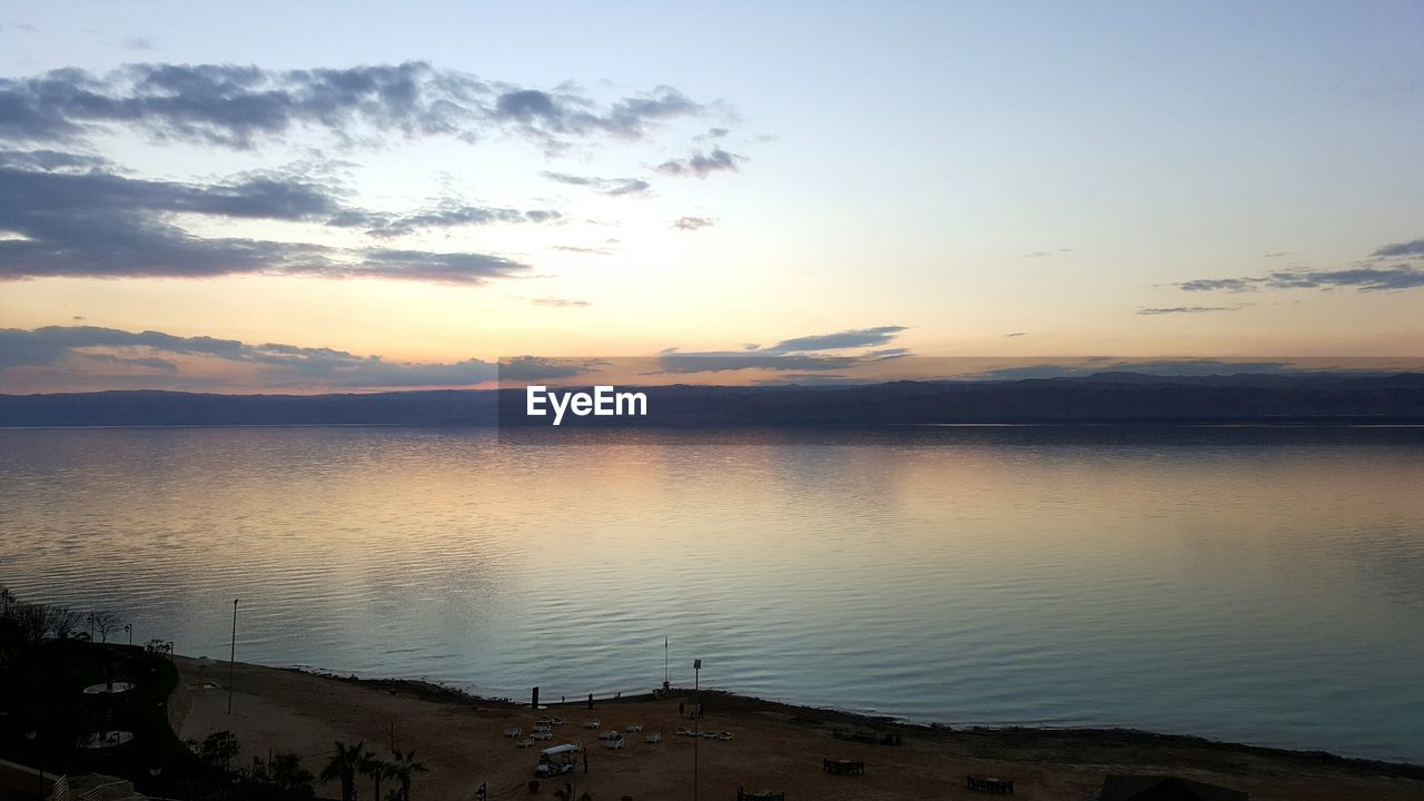 SCENIC VIEW OF LAKE AGAINST SKY DURING SUNSET