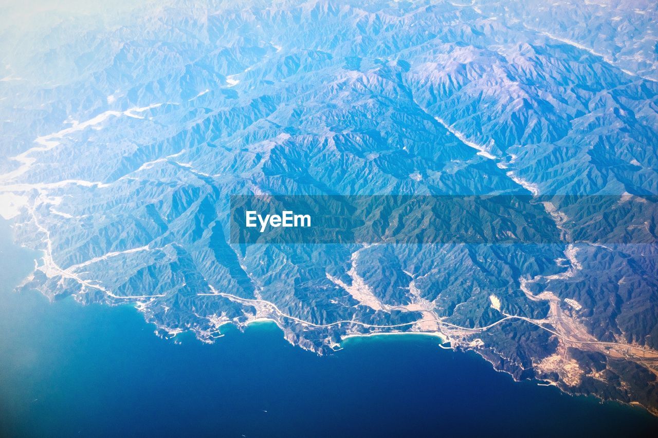 Aerial view of landscape by sea