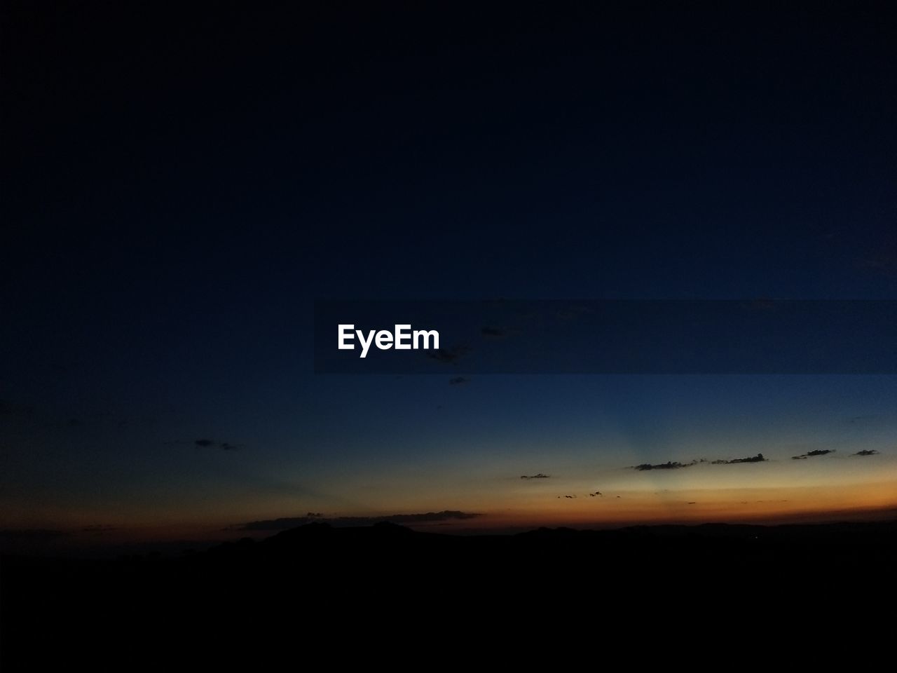 SCENIC VIEW OF SILHOUETTE LANDSCAPE AGAINST SKY AT DUSK