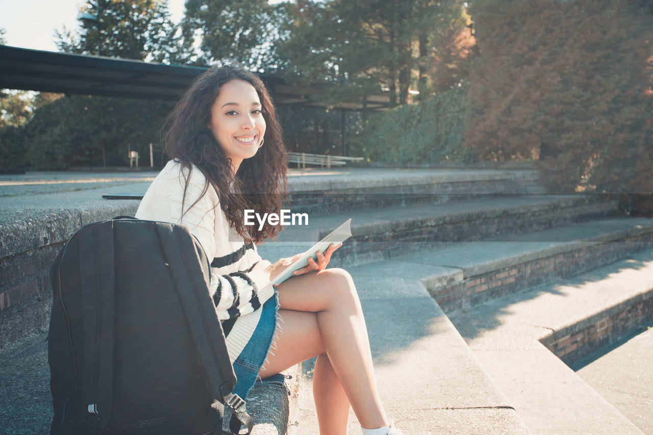 portrait of young woman using phone