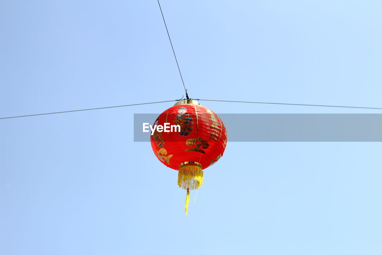 Low angle view of chinese lantern hanging against clear sky