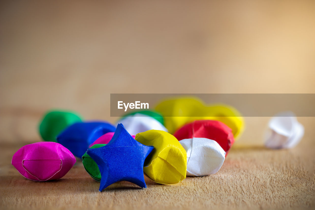 Close-up of multi colored stars on table