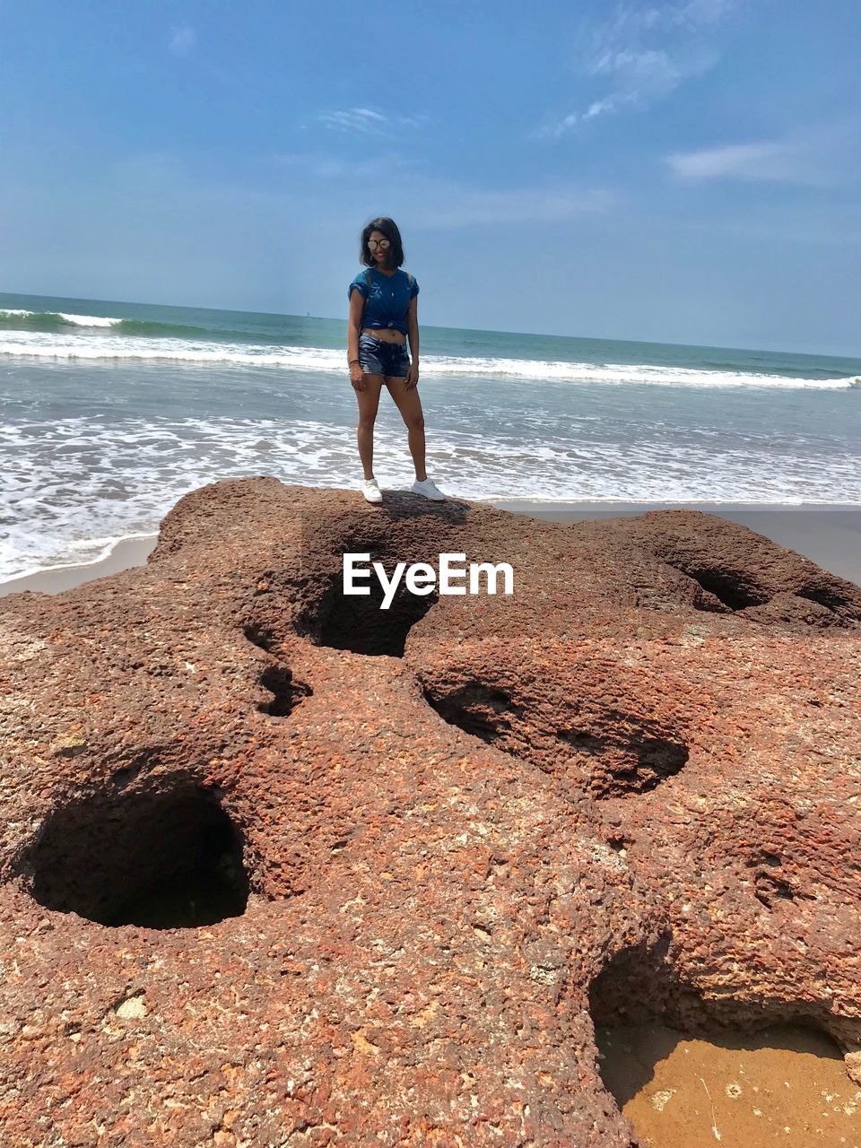 Full length of woman standing at beach