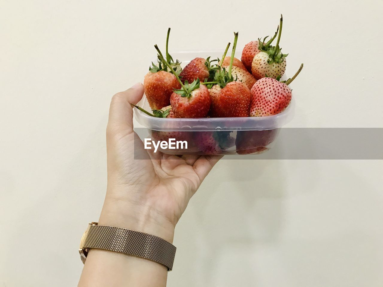 MIDSECTION OF PERSON HOLDING STRAWBERRIES