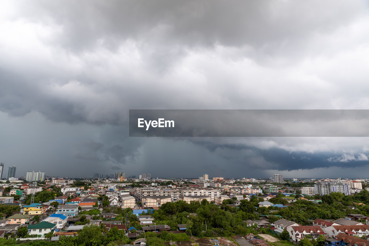 high angle view of townscape against cloudy sky