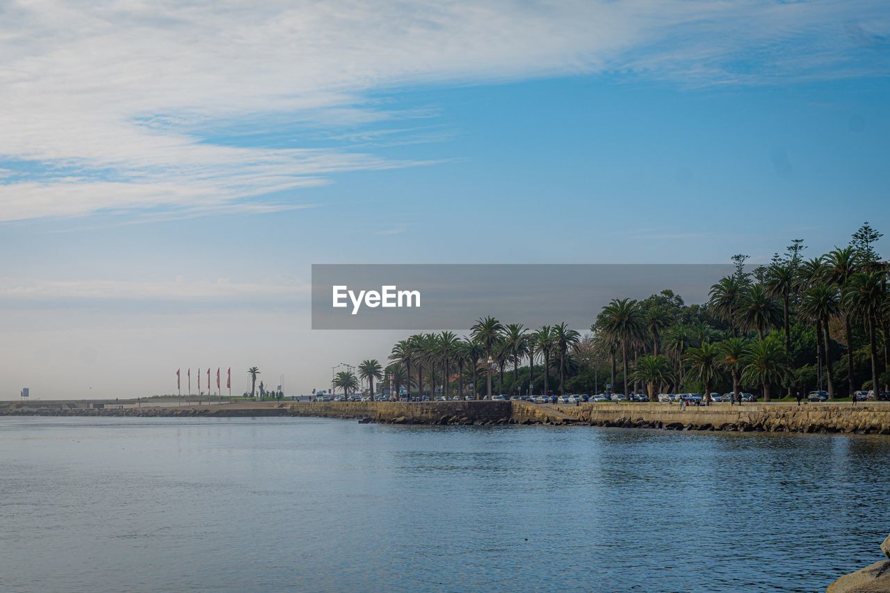 SCENIC VIEW OF SEA AGAINST SKY IN CITY