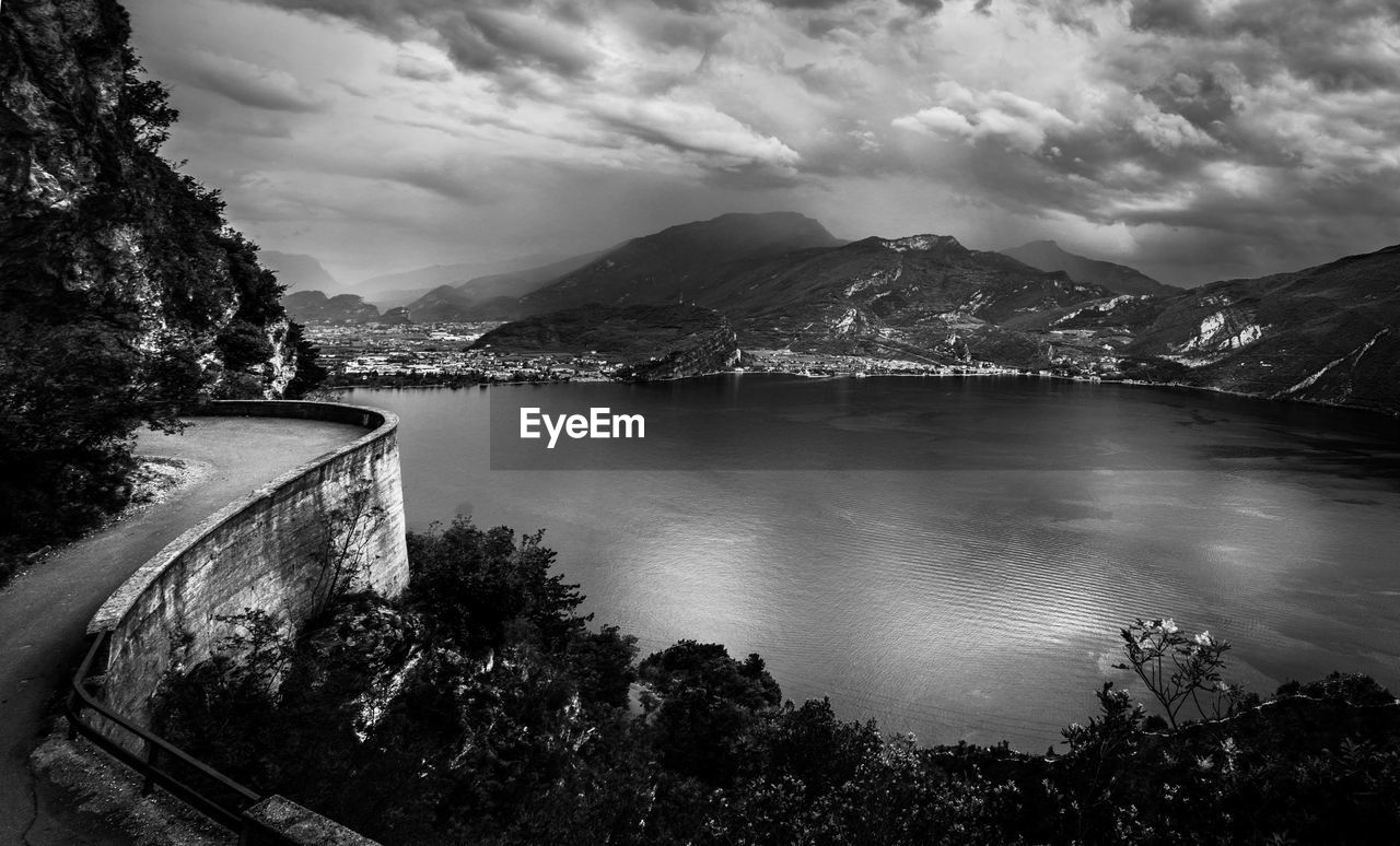 Scenic view of river by mountains against sky