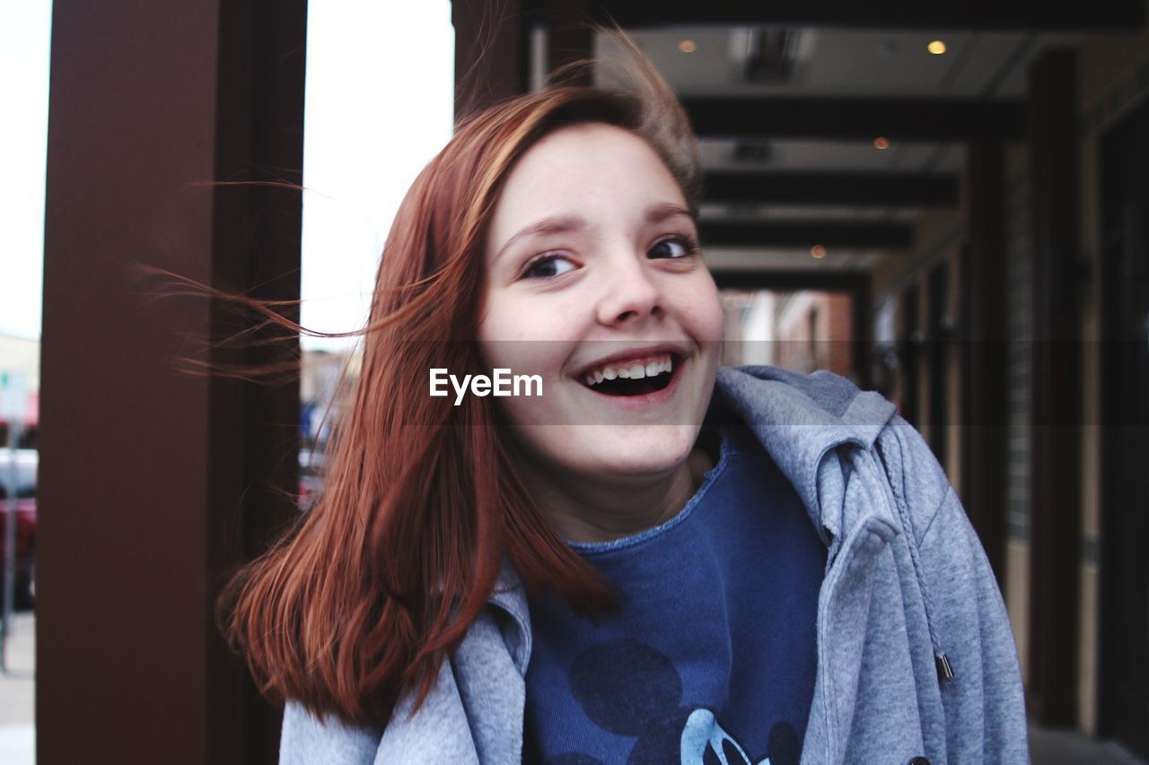 Smiling teenage girl looking away