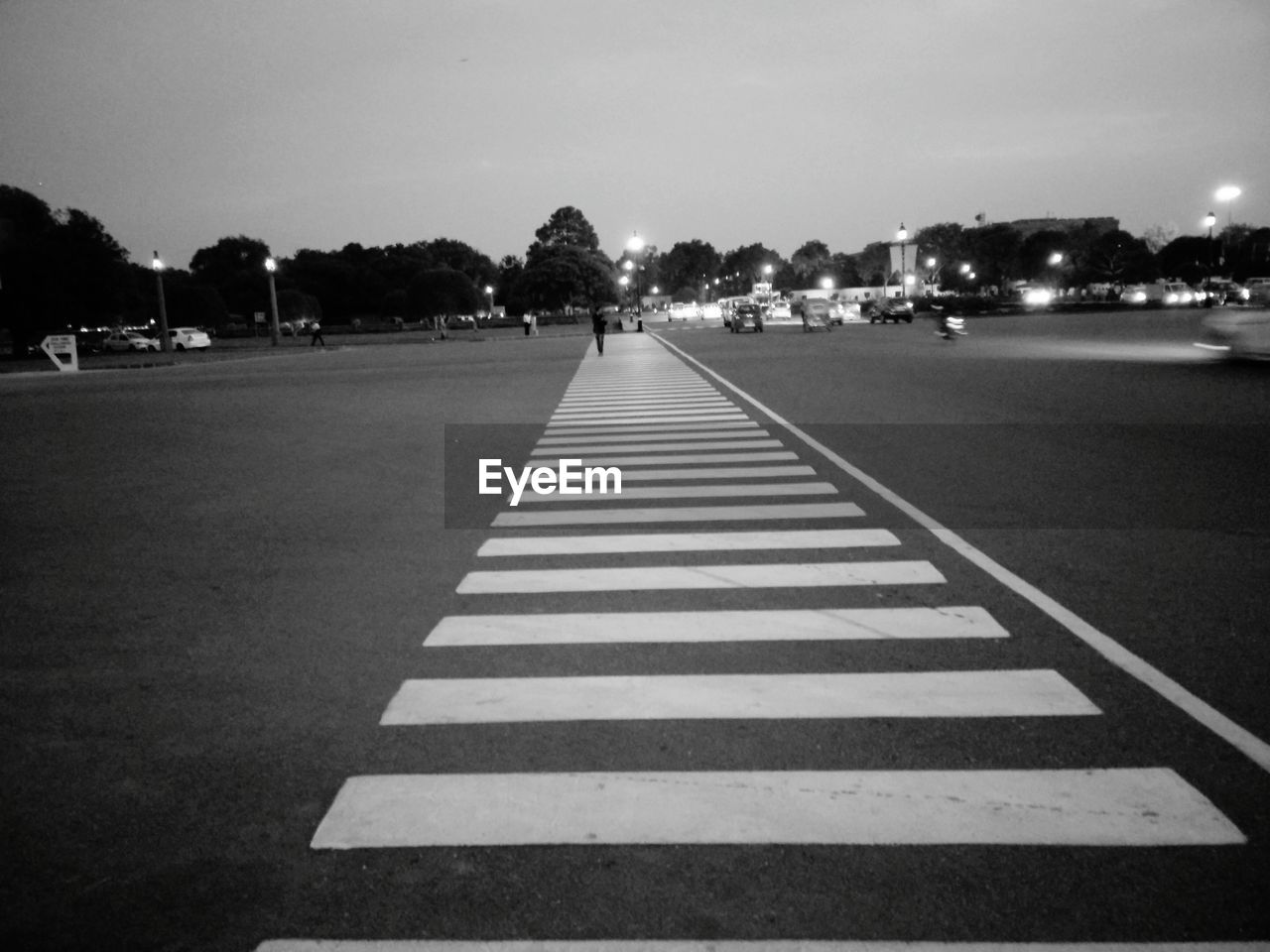 Zebra crossing on road against sky