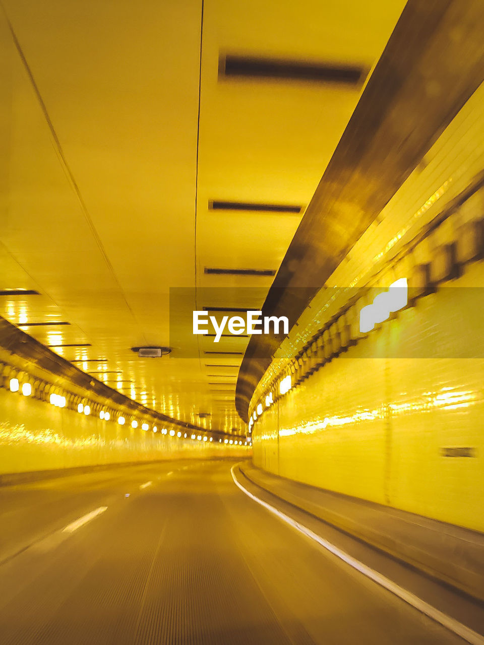 Interior of illuminated yellow tunnel