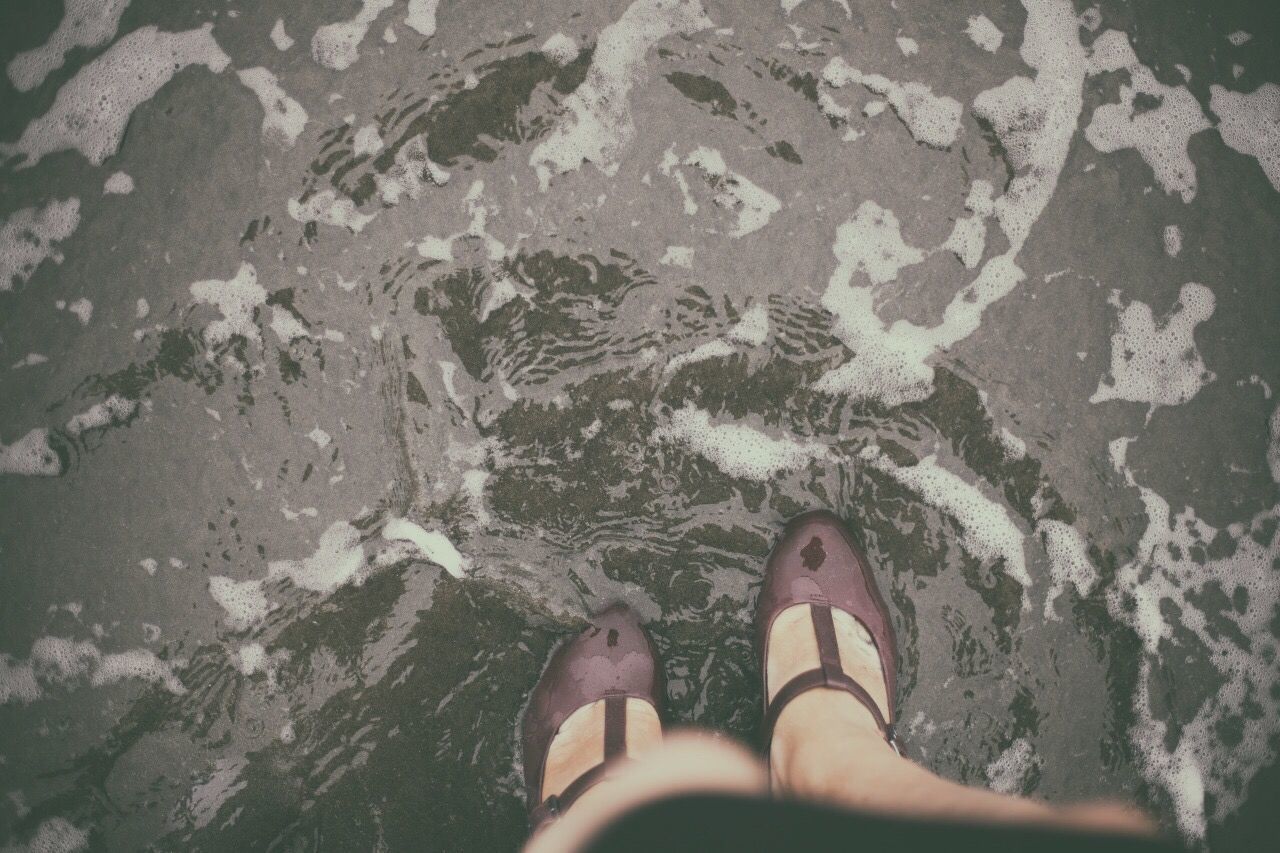 Low section of woman standing on ground