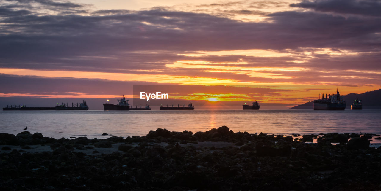 Silhouette of ships at sunset