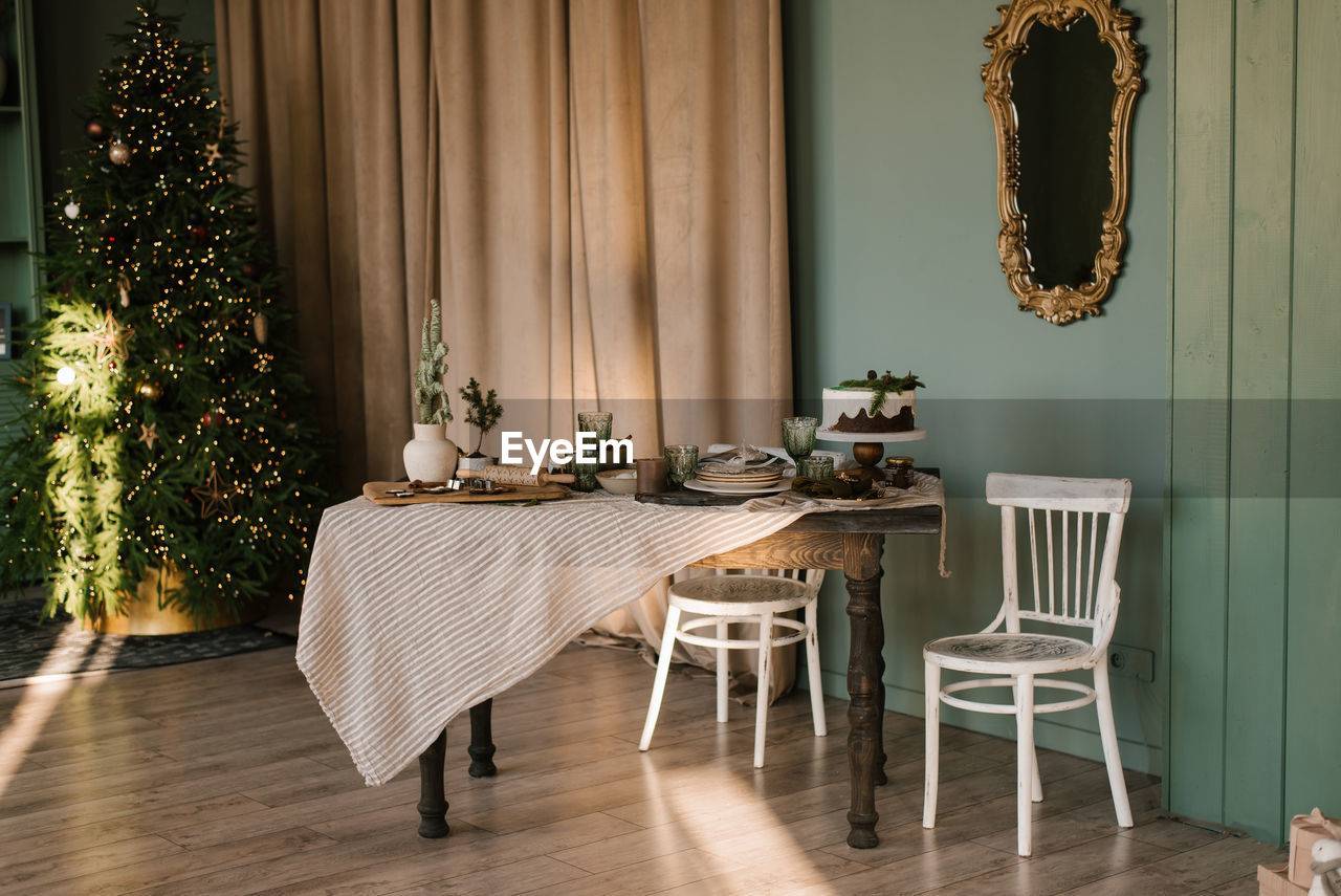 Beautifully decorated and served dining christmas table in the living room