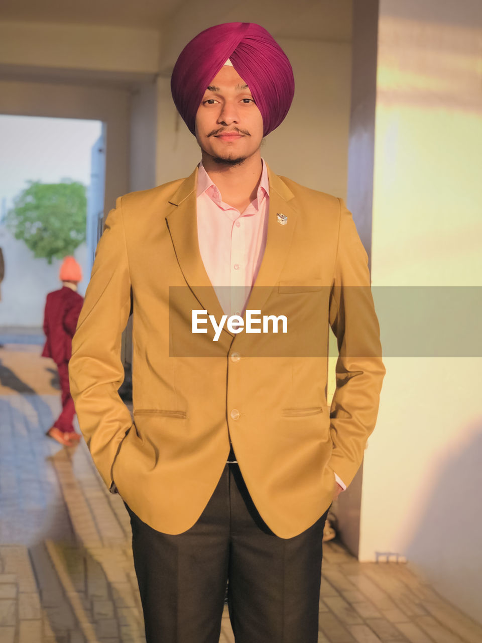 adult, one person, standing, clothing, men, portrait, business, fashion, three quarter length, front view, looking at camera, indoors, architecture, young adult, spring, jacket, yellow, lifestyles, business finance and industry, occupation, blazer, hat, outerwear, person, smiling, hands in pockets, emotion