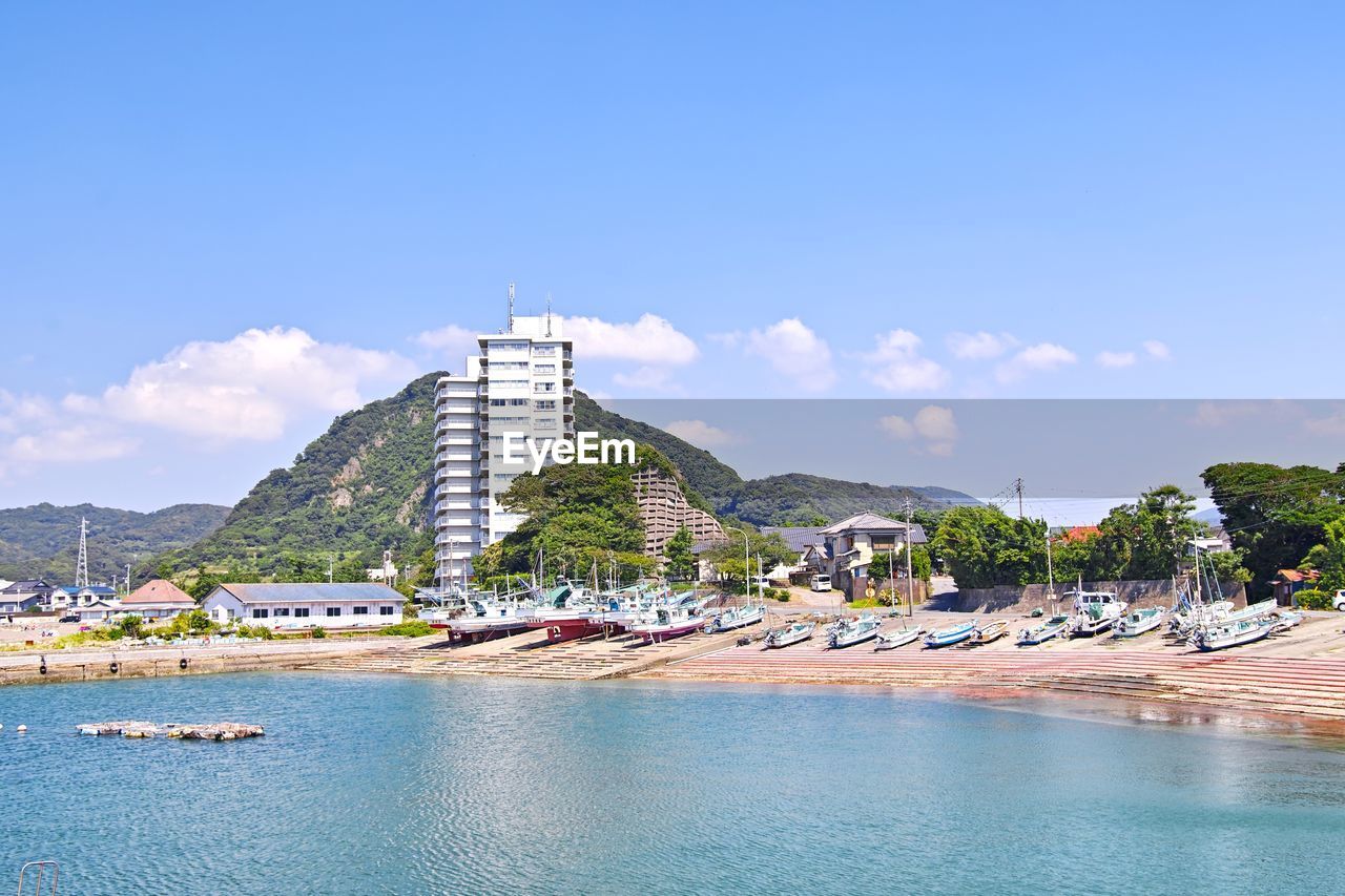 View of building by sea against sky