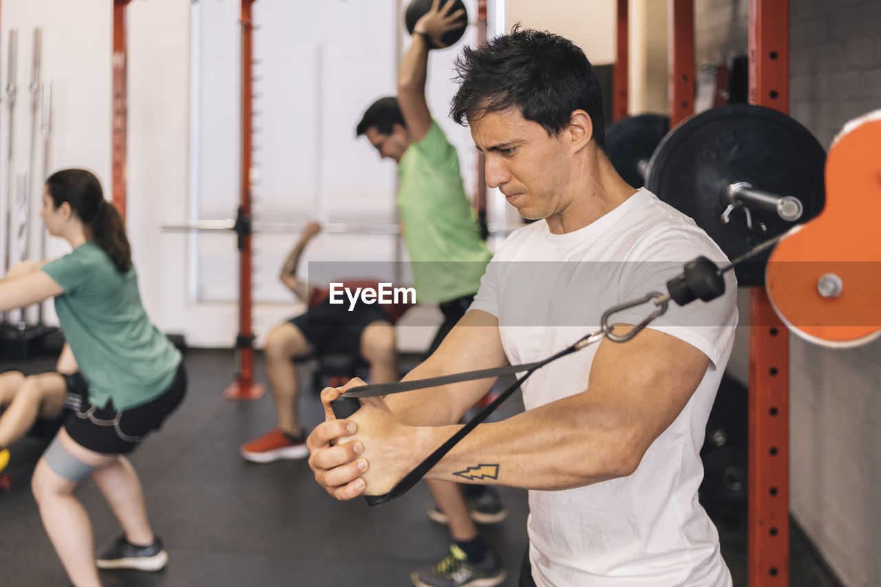 Group of beginners athletes exercising in a personal class with a private trainer. various exercises