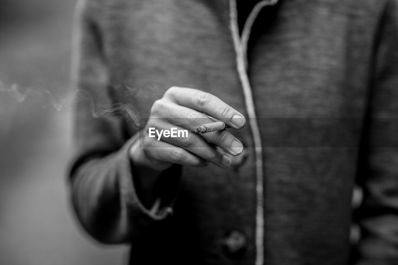 Close-up of woman holding cigarette