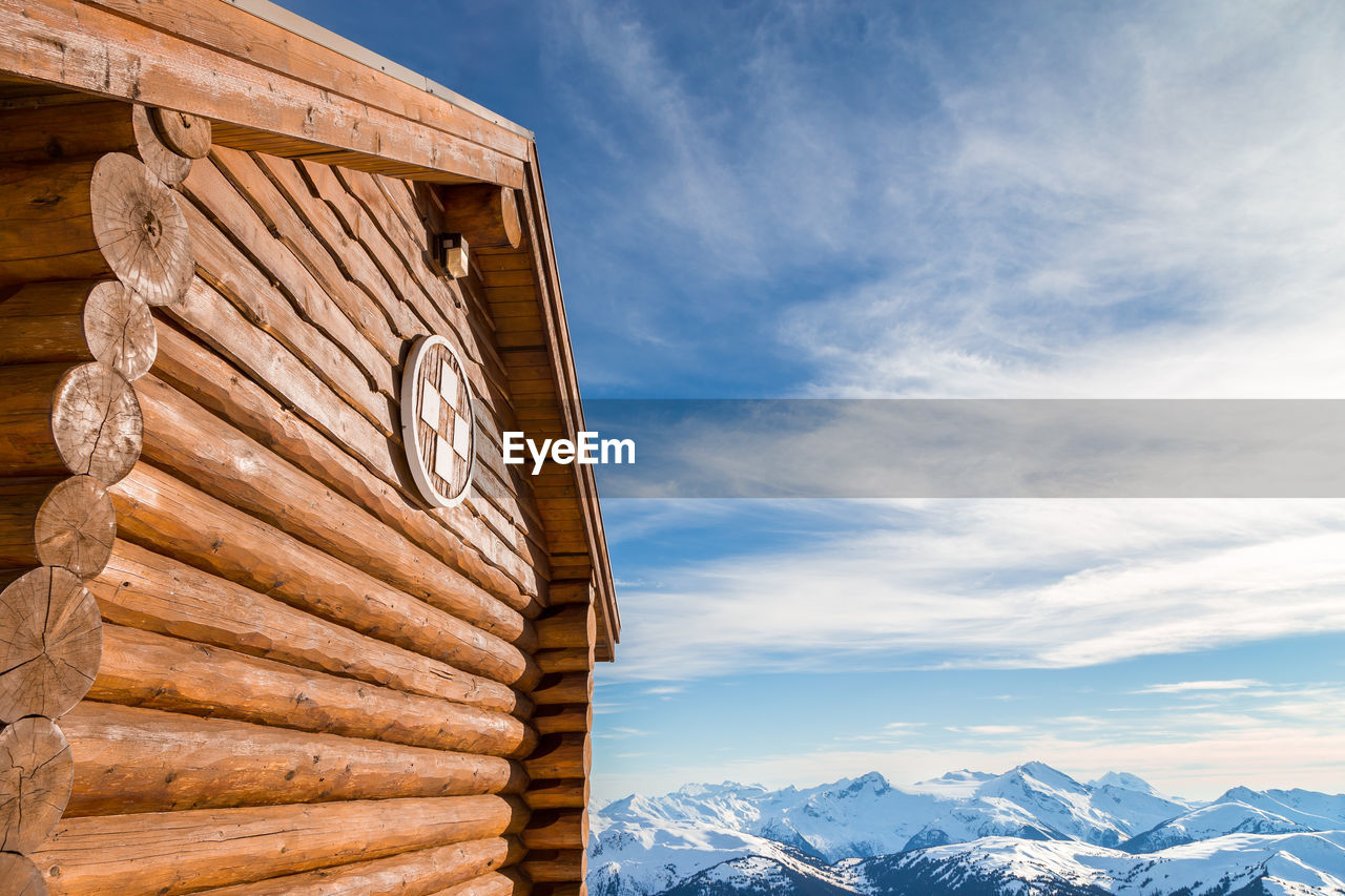 LOW ANGLE VIEW OF SNOWCAPPED MOUNTAIN AGAINST SKY DURING WINTER