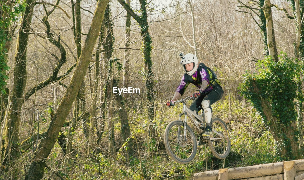 WOMAN WITH BICYCLE AND TREE