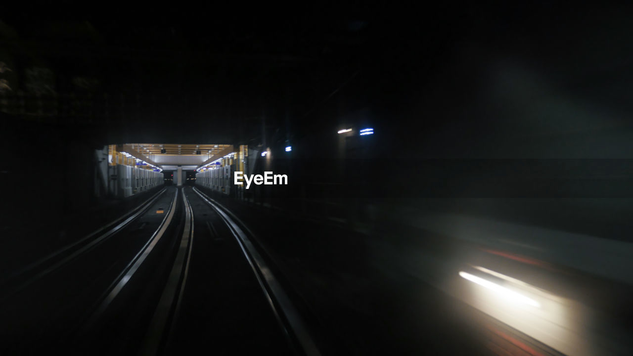 Blurred image of train moving on track at night