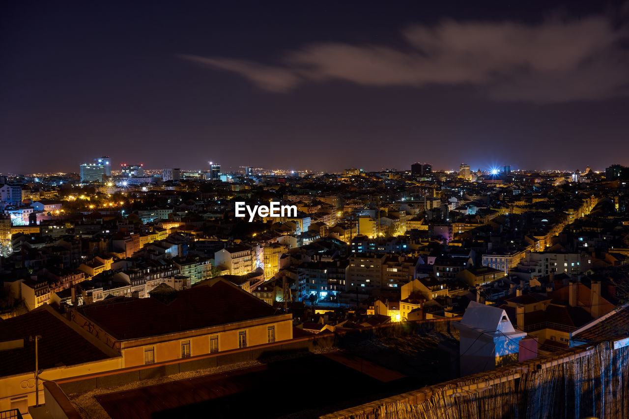 High angle view of illuminated cityscape against sky at night