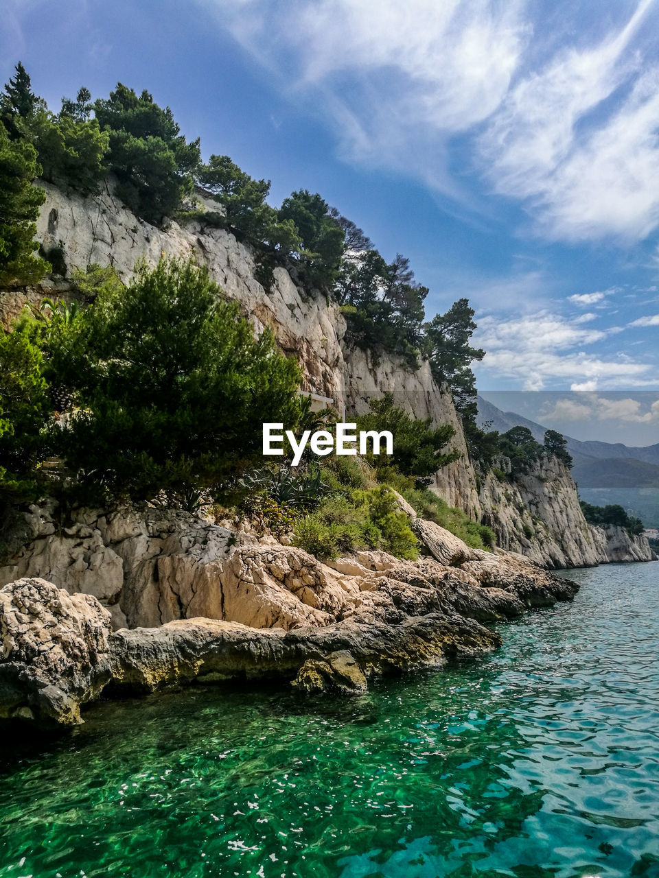 Scenic view of rocks in sea against sky