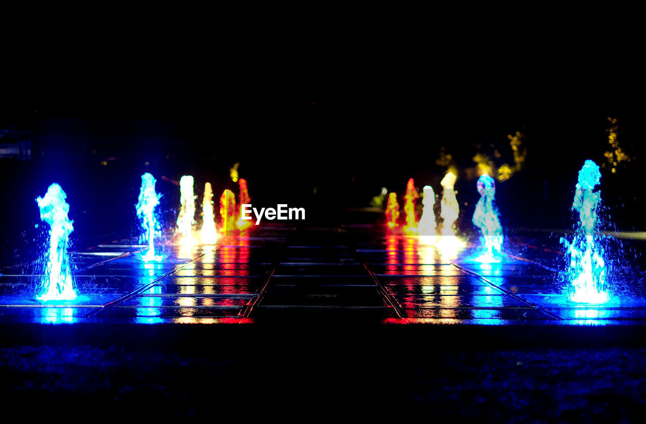 Illuminated fountain at night