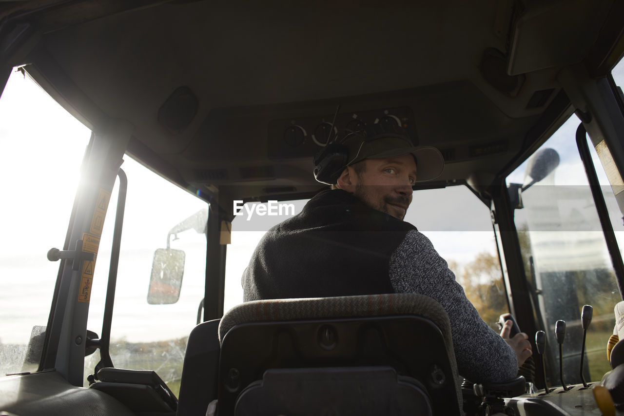 Farmer driving tractor