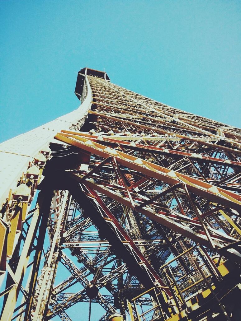 Low angle view of eiffel tower against clear blue sky