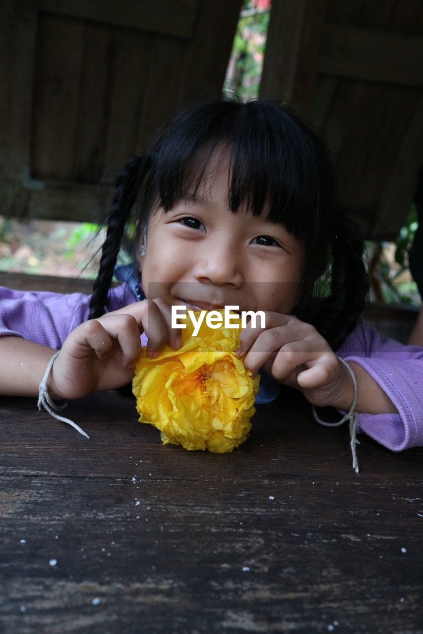 PORTRAIT OF CUTE GIRL HOLDING CHOCOLATE