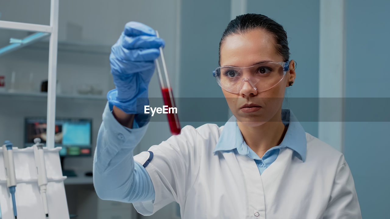 portrait of female doctor holding dentures