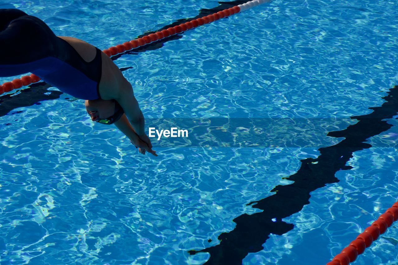 Woman jumping into pool