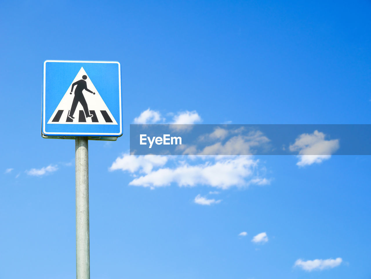 low angle view of road sign against clear blue sky