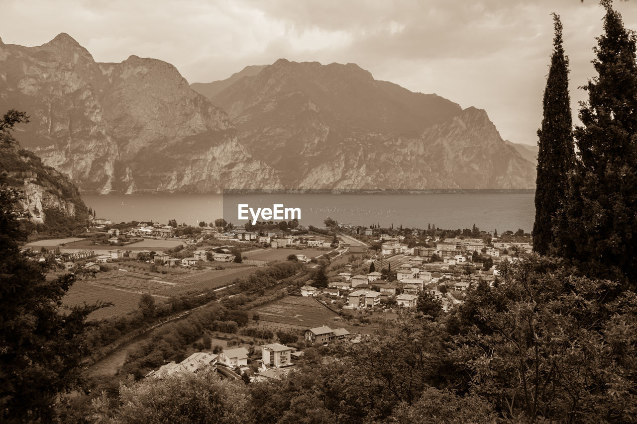 Panoramic view of townscape and mountains against sky