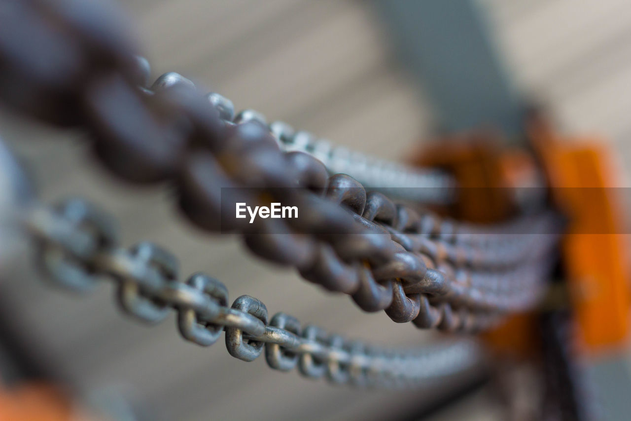 Close-up of metal chain on pulley