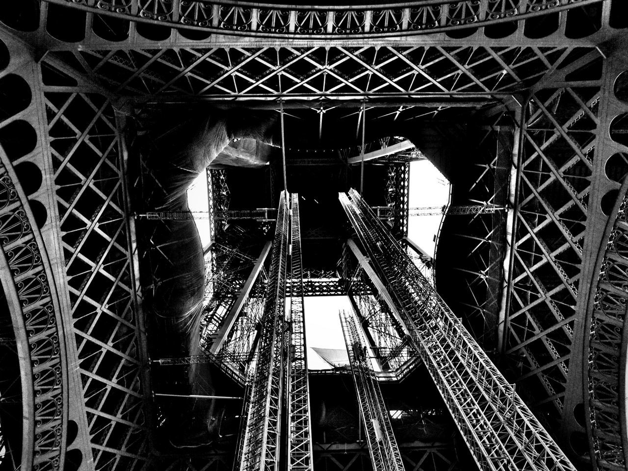 Looking up into eiffel tower
