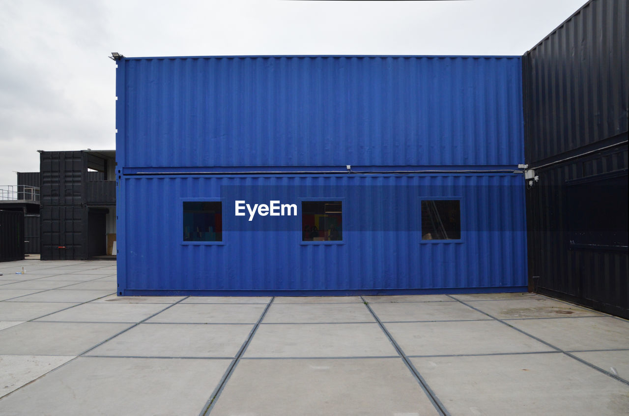 Blue and black containers in the harbor