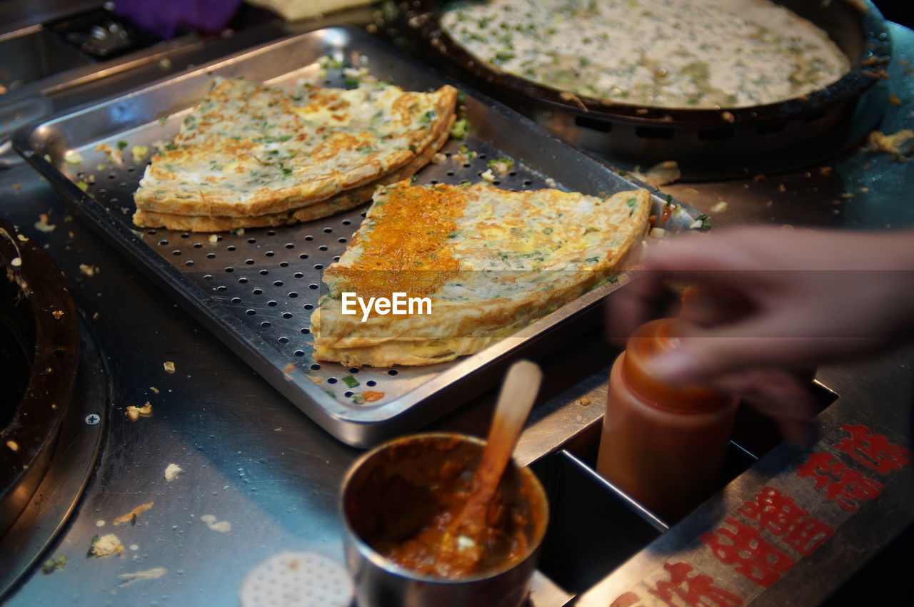 Cropped image of market vendor selling street food at night