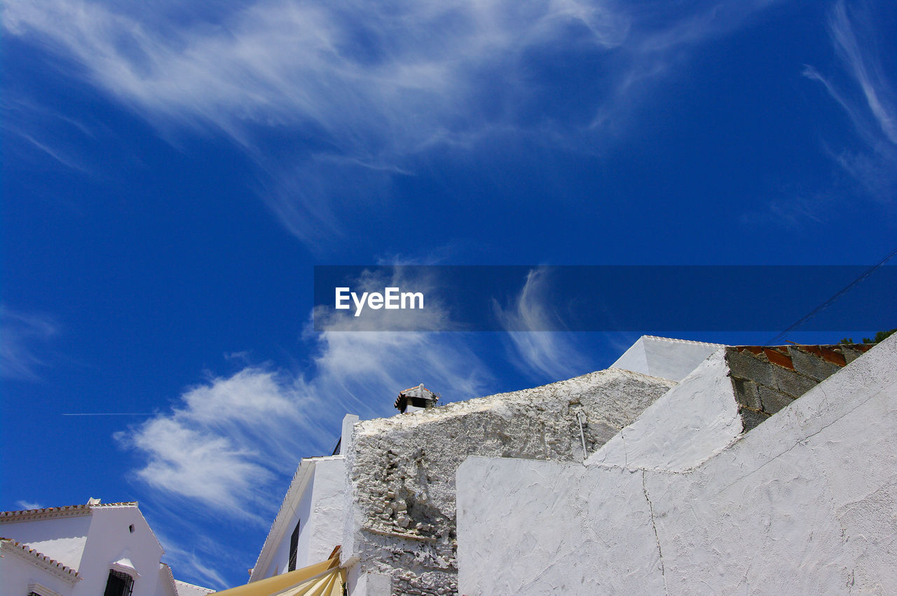 Low angle view of buildings against blue sky