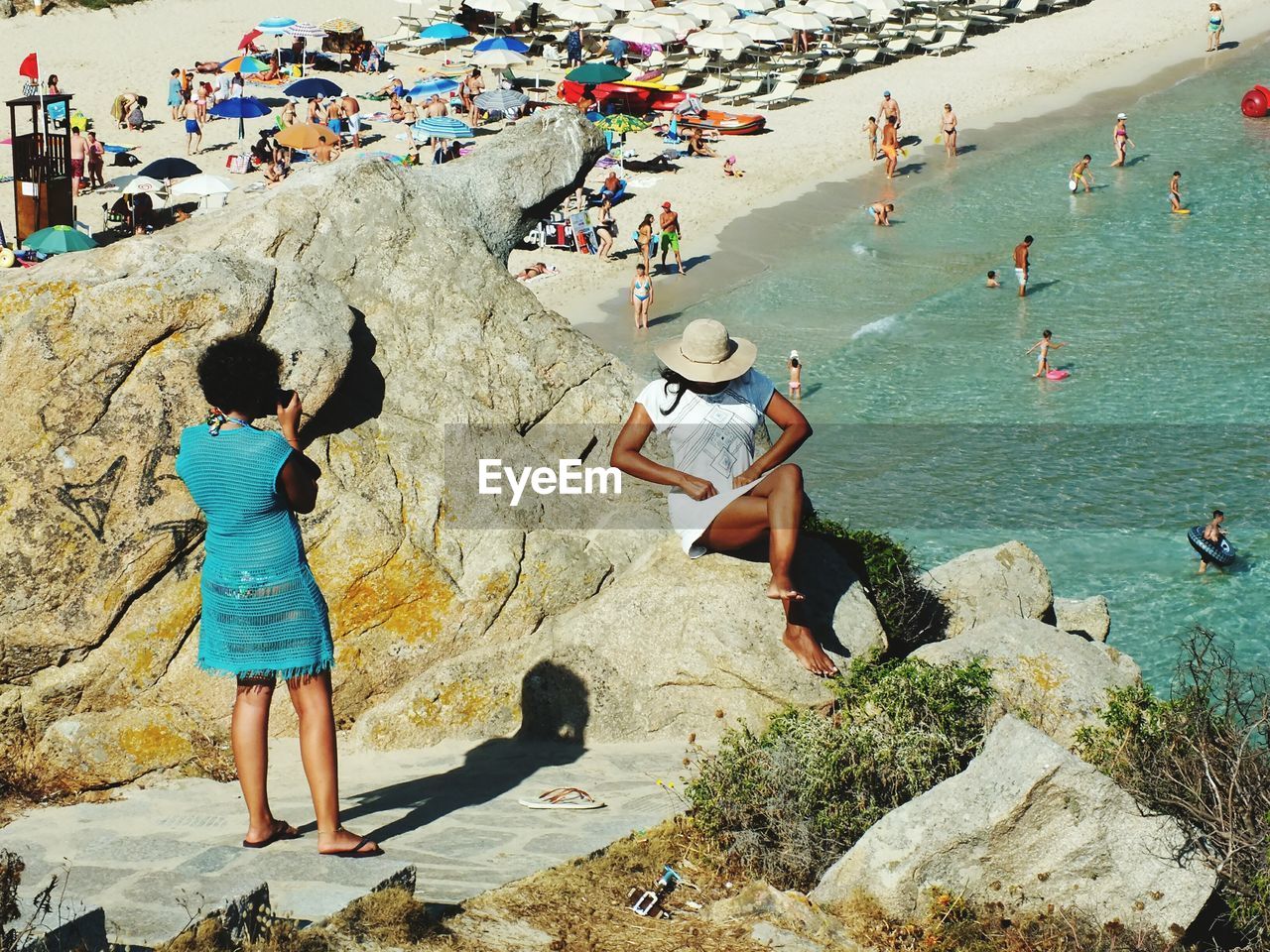 High angle view of people at beach during sunny day