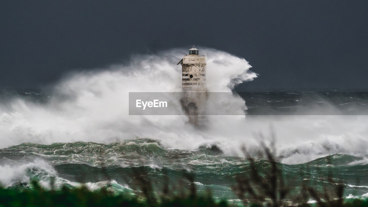 water, motion, lighthouse, wave, tower, sea, architecture, nature, building exterior, built structure, no people, sky, storm, ocean, wind wave, outdoors, building, land, travel destinations, environment, beauty in nature, cloud, wind, long exposure, power in nature, fog