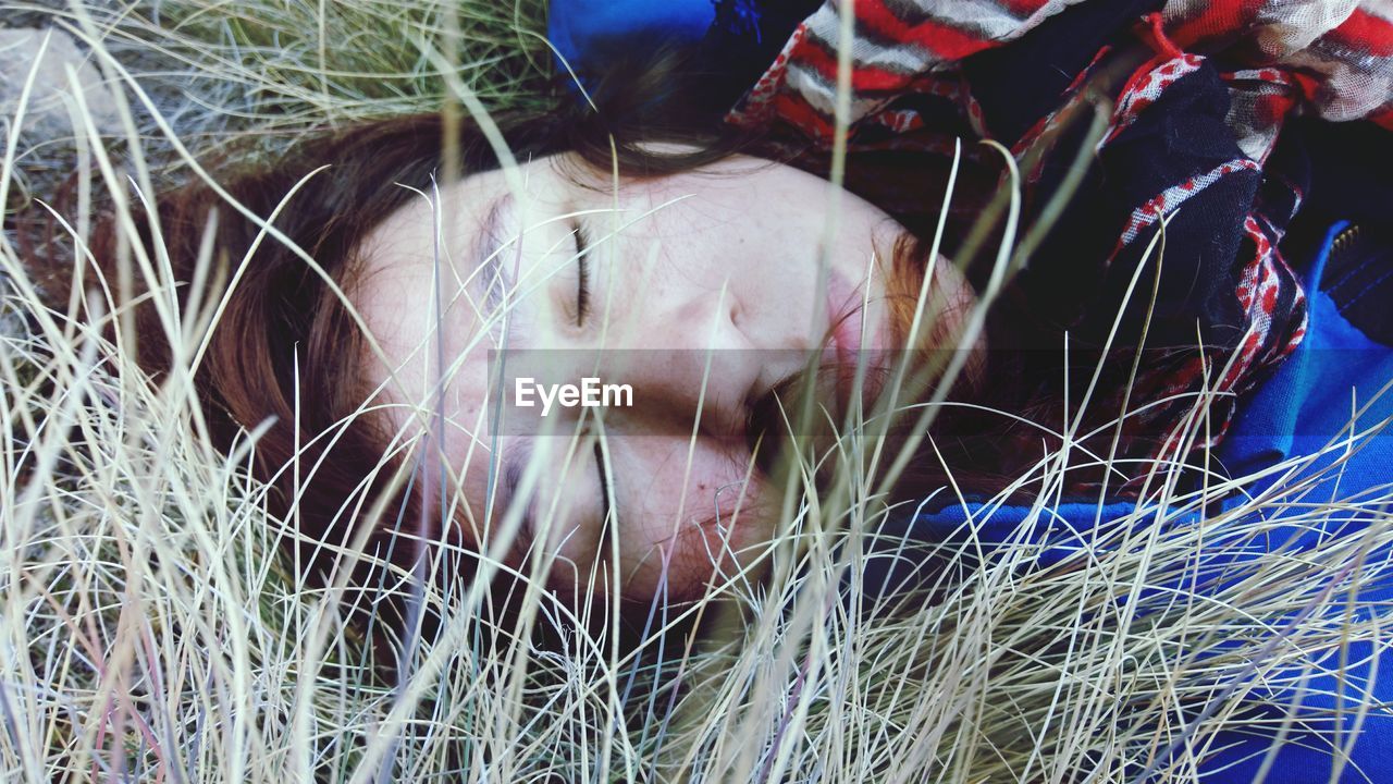 Close-up of sleeping woman in forest