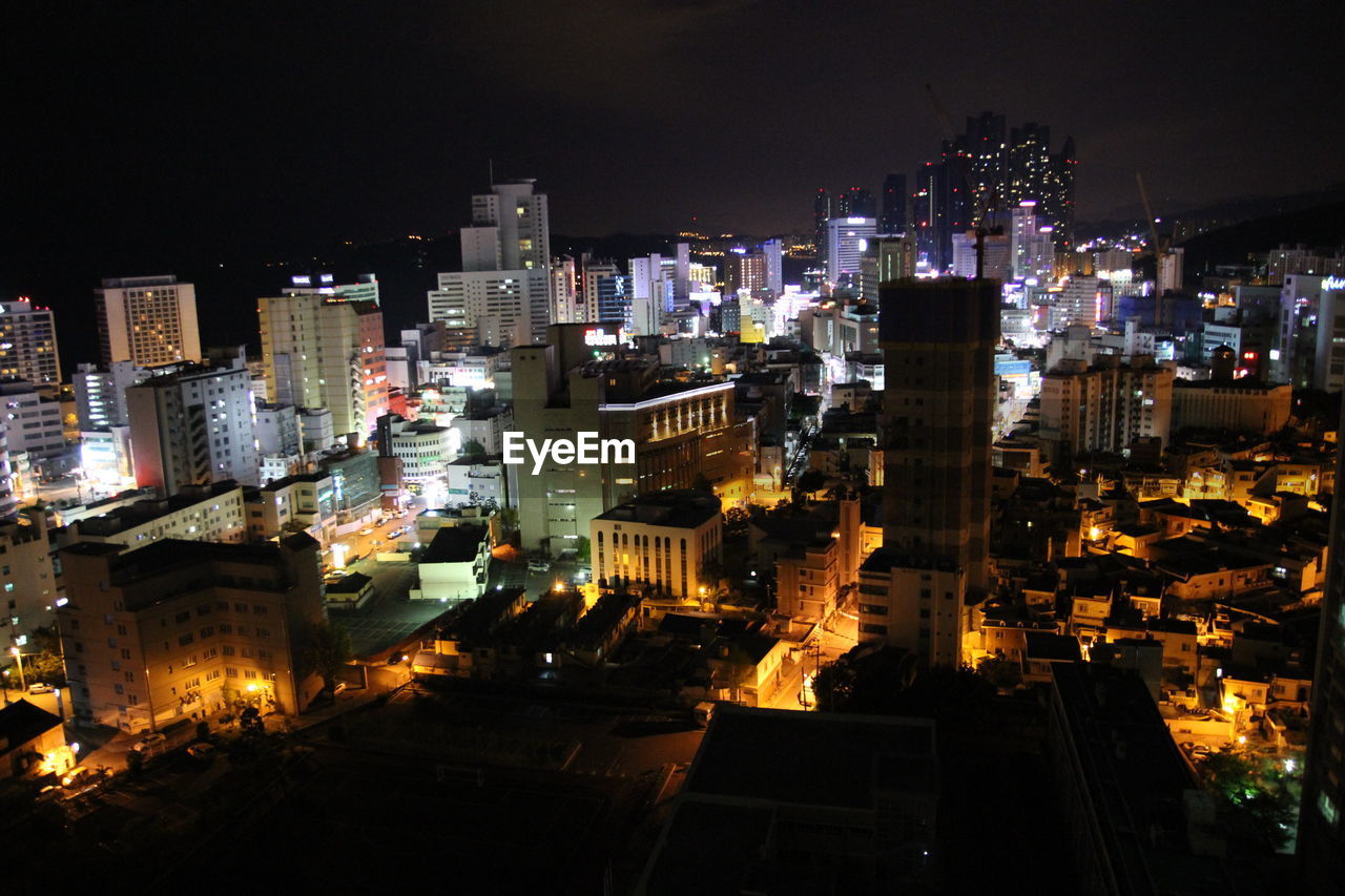 AERIAL VIEW OF ILLUMINATED CITYSCAPE