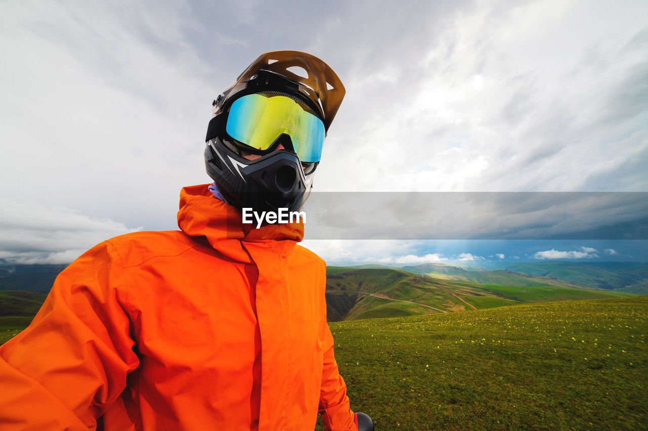 Portrait of a racer in full protection of a full face mask on a bicycle or motorcycle in the summer