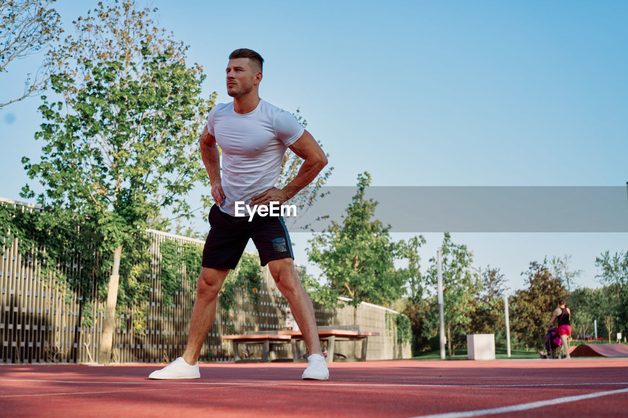 full length of young man exercising on road