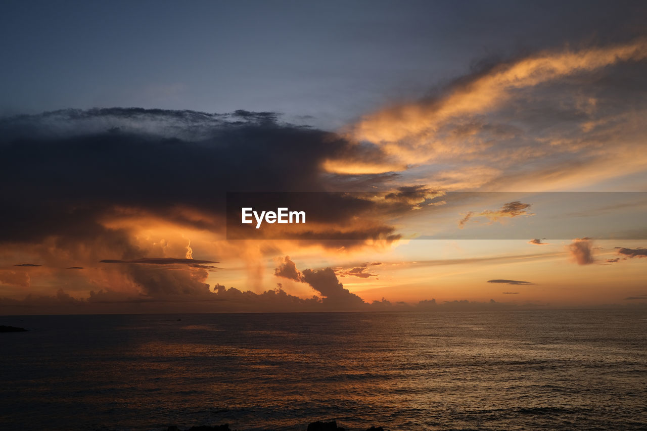 scenic view of sea against orange sky