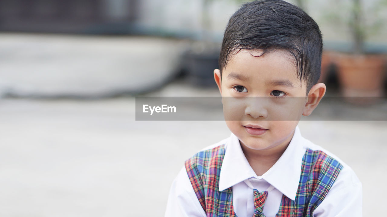 Portrait of cute boy standing outdoors